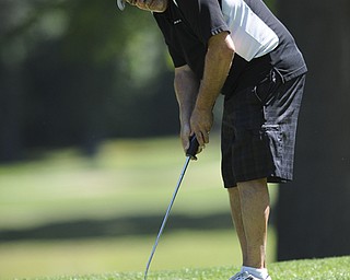 Golfer Joe Cannatti of Youngstown follows through on his putt as it makes its way to the hole on the 8th hole Saturday afternoon at Youngstown Country Club as part of the Vindy Greatest Golfer tournament on August 24.