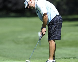 Golfer Mike Brinkcko of Canfield follows through on his putt as it makes its way to the hole on the 8th hole Saturday afternoon at Youngstown Country Club as part of the Vindy Greatest Golfer tournament on August 24.