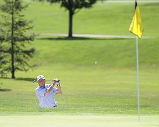 Golfer George Repaski chips his ball out of the satrap and onto the green on the 14th hole Saturday afternoon at The Lake Club as part of the Vindy Greatest Golfer tournament on August 24.