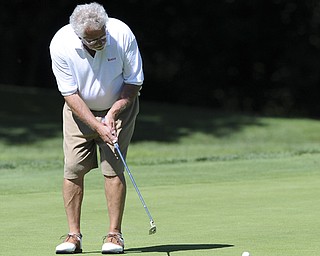 Golfer John Clacko of Canfield follows through on his putt on the 17th hole Saturday afternoon at The Lake Club as part of the Vindy Greatest Golfer tournament on August 24.