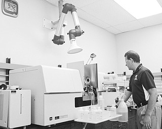 Scott Bolam, laboratory director, analyzes lead samples at the District Board of Health Laboratory in Austintown on Aug. 13.