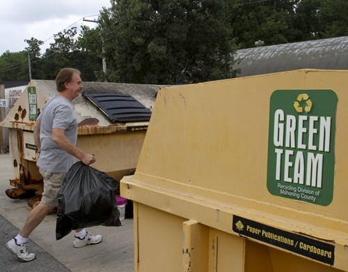William D Lewis the Vindicator Rich Jones of Poland deposits plastic items at Poland recylcing center 8-19-13