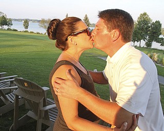 William d Lewis the Vindicator GGOV open winner Jonah Karzmergets a kiss from his wife Beth Karzmer after winning Sunday at the Lake Club.