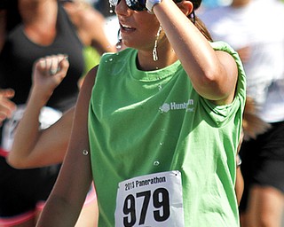 MADELYN P. HASTINGS | THE VINDICATOR..*** pours water on her head after completing her race in the Panerathon held at the Covelli Centre on August 25, 2013. The Panerathon is the largest community fundraising event in the Youngstown area that benefits the Joanie Abdu Comprehensive Breast Care Center.... - -30-..