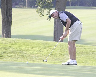 Joe Castor follows his putt to the hole on the sixth hole of The Lake Club in Poland during rhe Greatest Golfer of the Valley tournament on Sunday.  Dustin Livesay  |  The Vindicator  8/25/13  Poland.