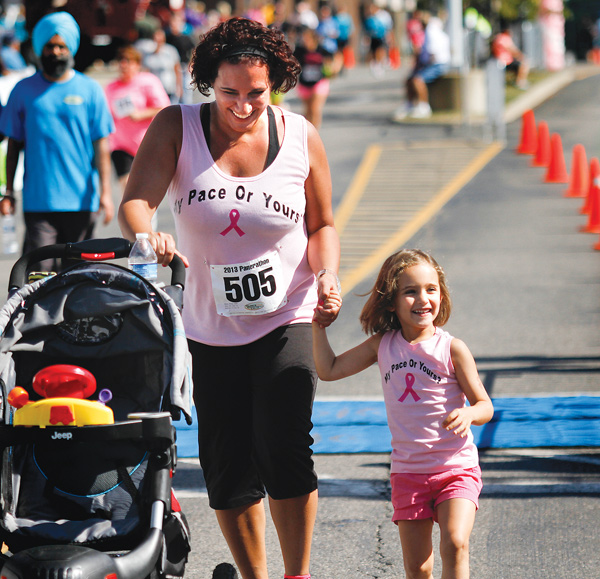 Chrisy Davis and her daughter Gabriella, 3, of Austintown finish their benefit walk together.