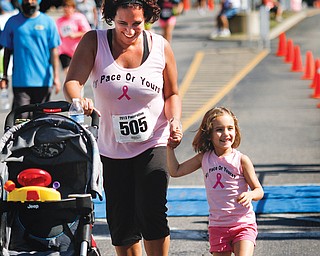 Chrisy Davis and her daughter Gabriella, 3, of Austintown finish their benefit walk together.