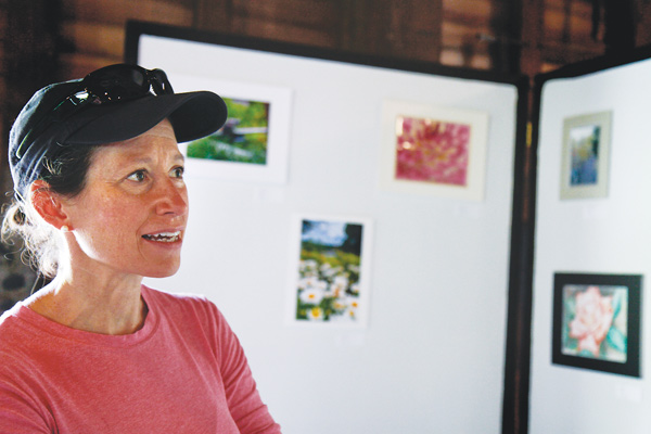 Linda Lambert of Bethesda, Md., admires the artwork on display in the Lanterman’s Mill art show, which ran Friday through Sunday on the second floor of the mill. Artwork included photographs, paintings and drawings.