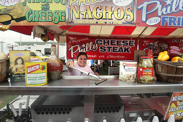 Margie Brady of the Original Philly Cheese Steak gets her concession stand ready for the opening of the 167th
Canfield Fair today. She and other vendors spent Tuesday preparing for the six-day fair, which ends Labor Day.