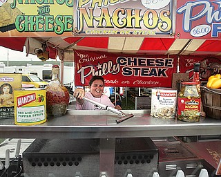 Margie Brady of the Original Philly Cheese Steak gets her concession stand ready for the opening of the 167th
Canfield Fair today. She and other vendors spent Tuesday preparing for the six-day fair, which ends Labor Day.