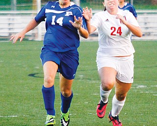 Canfield’s Marissa Severino (24) steals the ball from Poland’s Phoebe Bush (14) during their soccer match Wednesday at Canfield High School. The Cardinals routed the Bulldogs, 10-0.