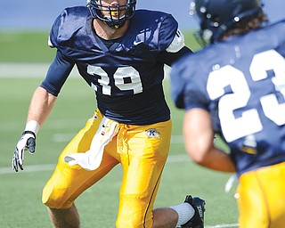 Kent State DBs Luke Wollet (39) and Jordan Italiano (23) run a play during a recent practice at Dix Stadium. Wollet,
a Poland High School graduate, is returning for is senior year as a team leader and captain of the defense, on which Italiano, a sophomore and Canfield graduate, will start at the star position. Colin Reardon, another Poland grad, earned the nod as starting quarterback as a red-shirt freshman.
