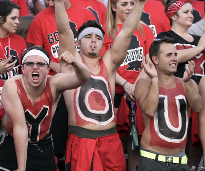 William d Lewis The Vindicator  YSU students l-r Ansel Morsillo, Tyller(CORRECT) Schonce and Jason Heyman show their penguin spiriit during opener Thursday with dayton. They and other students spelled YOUNGSTOWN on thier chests.
