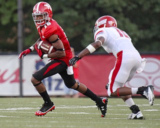 William D Lewis The Vindicator YSU'sMarcel Caver(16) scampers for yardage past Dayton's Luke Welsh(15)during 1rst half action Thursday 8-28-13.