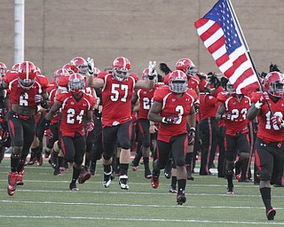 William D LEwis YSU Adaris Bellamy (13) leads the Penguins onto the field for Thursday opener with Dayton.