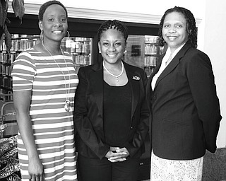 MADELYN P. HASTINGS | THE VINDICATOR: From left, Chantelle Hallman; Dr. Michelle McCollin, chapter president; and Dr. Sherri Lovelace-Cameron gather in the Youngstown Main Library to promote Delta Sigma Theta’s 100th anniversary Black Excellence banquet.