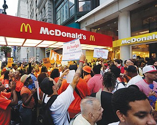 Protesting fast-food workers demonstrate outside a McDonald’s restaurant on New York’s Fifth Avenue on Thursday. Thousands of fast-food workers staged walkouts in dozens of cities around the country Thursday,
part of a push to get chains such as McDonald’s, Taco Bell and Wendy’s to pay workers higher wages.