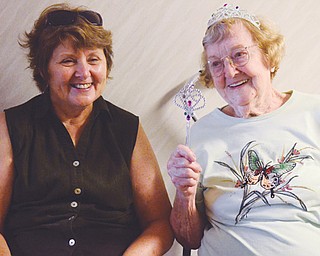 Alfreda Robinson, right, shares a laugh with her daughter, Carolyn Lorent, during Robinson’s 100th birthday party Thursday at Fit Family in Austintown. The Niles native, who now lives in Lake Milton with her daughter, works out at the gym twice weekly.