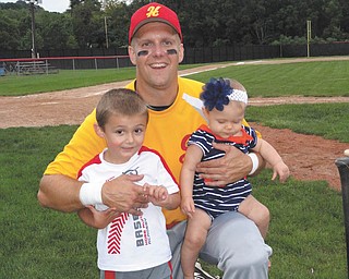 Jim Putko of Boardman with his son Jimmy, 4, and daughter Julia, 8 months, who cheered for their daddy through his final baseball game of the year. Sent by Casey Putko.