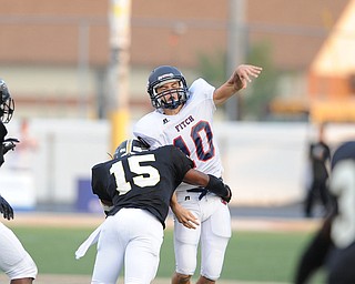 Fitch quarterback #10 Gabe Chepke throws the ball away while being hit by Harding linebacker #15 Keith Adams during the 1st quarter during a game on Friday August 30, 2013.