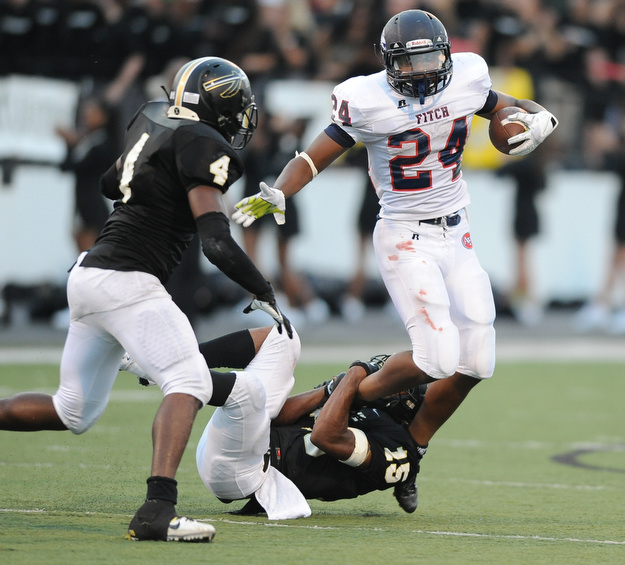 Fitch running back #24 Darrin Hall attempts to slip out of a tackle by Harding #15 Keith Adams in the 2nd quarter during a game on Friday August 30, 2013. Harding #4 Tyron Howard pictured.