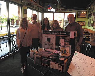 At the Quaker Steak & Lube National Chicken Wing Day and raffle, the Youngstown Lions Club earned $510. The money will be used to buy backpacks for Youngstown City School students. The Lions will add $200 for school supplies to fill the backpacks. Some of the Lions members involved, from left, are Nancy Cuffle of Poland, King Lion; Pete Storey of Austintown; Michele Ballone of Lowellville; Josie Polis of Poland; and Bill Cooper of Austintown. Photo: Special to The Vindicator
