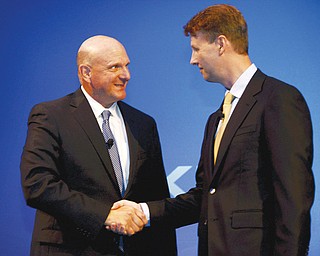 Microsoft CEO Steve Ballmer, left, shakes hands with Nokia’s Chairman of the Board Risto Siilasmaa during the press conference of the Finnish mobile manufacturer Nokia. U.S. giant Microsoft is set to buy Nokia’s mobile-phone business and patents.