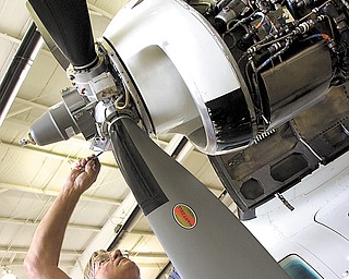 Ron Butler, engine-shop supervisor for Winner Aviation, lubricates a propeller on a MU2 B40 aircraft at Youngstown-Warren Regional Airport in Vienna. Winner Aviation has been at the airport since the mid-1990s, and the staff performs myriad duties there.