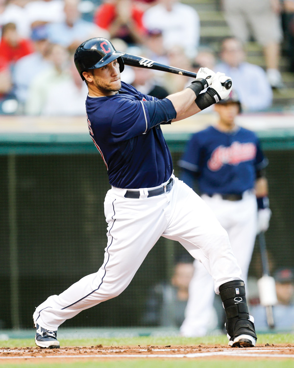 Cleveland Indians’ Yan Gomes hits an RBI-single off Baltimore Orioles starting pitcher Zach Britton in the first inning of a game Wednesday in Cleveland.