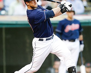 Cleveland Indians’ Yan Gomes hits an RBI-single off Baltimore Orioles starting pitcher Zach Britton in the first inning of a game Wednesday in Cleveland.