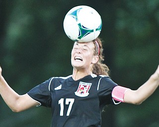 Canfield’s Emma Sybert (17) heads the ball during action Wednesday night during a match against All-American Conference rival Howland. Canfield won, 2-1.