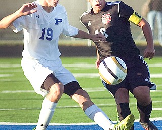 Poland’s Anthony Sabula fights for control of the ball against Canfield’s Jona Ghossain during their soccer match
Thursday at Dave Pavlansky Field in Poland. Sabula scored a goal for the Bulldogs, who shut out the Cardinals, 2-0.