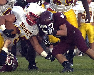 Kelli Cardinal/The Vindicator.Cardinal Mooney fullback Anthony Dermotta comes head to head Friday night against Boardman defender Mario Graziani at Boardman.