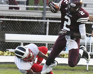 William DLewis The Vindicator  Liberty's Asim Pleas( 2) is tripped up by Niles(2) Marcus Hill during 2nd qtr action at Liberty 9-6-13.