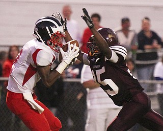 William DLewis The Vindicator  Niles Marcus Hll 2) pulls in a pass while Liberty (25)Khyri Davis defends during 2nd qtr action at Liberty 9-6-13.