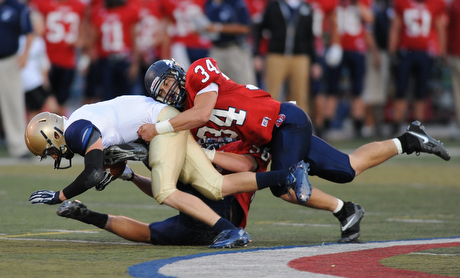 Hoban #3 is drug down by Fitch defenders #34 Sam Ortz and #50 Ryan Sayers on a speed sweep play early in the first quarter of a game on Friday September 6, 2013.