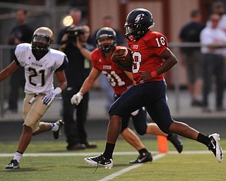 Fitch #18 Antwan Harris crosses the goal line to score a touchdown during the first half of a game on Friday September 6, 2013. Fitch #81 Austin Hogan and Hoban #21 Tyler Gilchrist pictured.