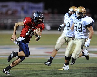 Fitch #10 Gabe Chepke cuts back across the field for extra yardage after breaking to the open and getting pat Hoban #59 Tristian Roothenbuecher and #42 Travis Pero. He would score on the play during the first half of a game on Friday September 6, 2013.