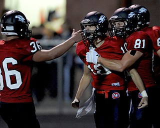 Fitch #10 Gabe Chepke celebrates with teammates #81 Austin Hogan and #36 C.J. Martini after scoring a rushing touchdown in the first half of a game on Friday September 6, 2013.