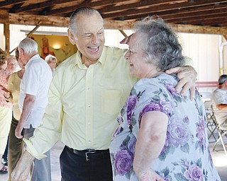 Andy and Lucy Szmerekovsky of Bedford share a laugh while dancing at the Youngstown American Hungarian Club’s annual Hungarian Heritage Day on Sunday.