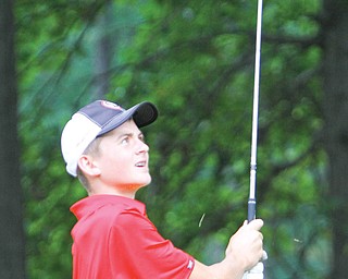 Mooney’s Ken Keller brings up a divot while making an approach shot from the rough during Monday’s match at
Mill Creek.