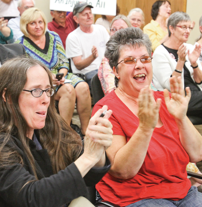 Audience erupts in applause after Mahoning County Bd of Elections announced Community Bill of Rights will remain on ballot during Friday 9-6-13 meeting. In foreground are Jane Spies, left, of Hubbard and Trudee Weatherby of Youngstown.