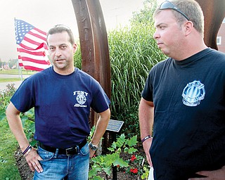 New York Fire Department members Nick Mincone, left, and Mike Kahlua look over a memorial at the Austintown 9/11 Memorial Park. The two will speak at Austintown’s 9/11 ceremony at 6 p.m. today.