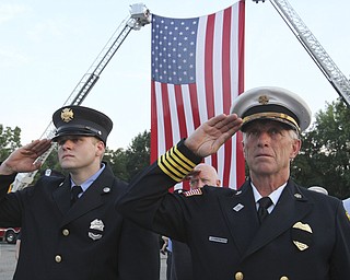 William D. Lewis The Vindicator Ellsworth twp firefighter Jeremy Hartman, left, and Ellsworth FD Chief Sherman Yeager during 9-11 ceremony in Austintown Wed.