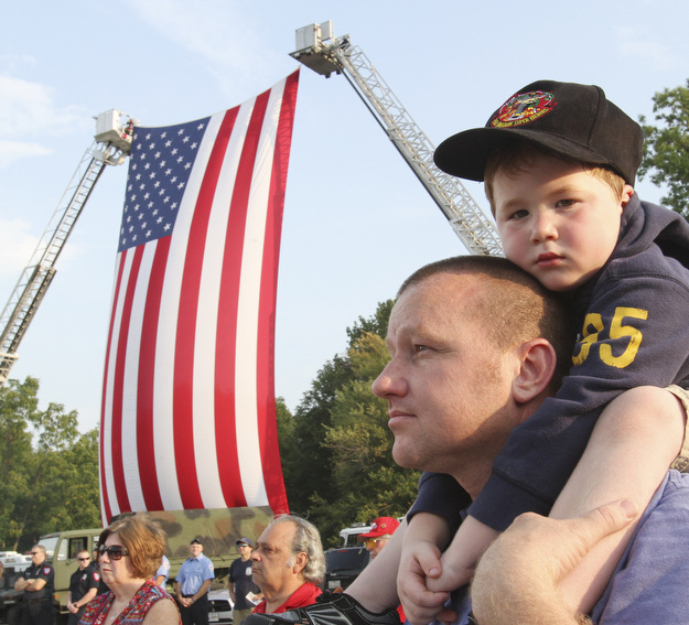 William D. Lewis The Vindicator Ken Blair of Youngstown and his son Mikey, 4,  during 9-11 ceremony in Austintown Wed.