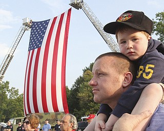 William D. Lewis The Vindicator Ken Blair of Youngstown and his son Mikey, 4, during 9-11 ceremony in Austintown Wed.