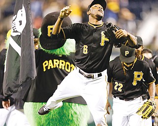 Pirates left fielder Starling Marte (6) celebrates Pittsburgh’s 3-1 win over the Chicago Cubs as he heads for the dugout after Thursday’s game in in Pittsburgh.
