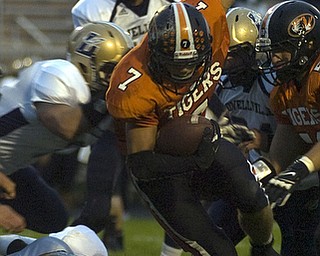 Kelli Cardinal/The Vindicator .Springfield ball carrier Anthony Scandy is brought down Friday night by Lowellville defenders at Springfield High School.