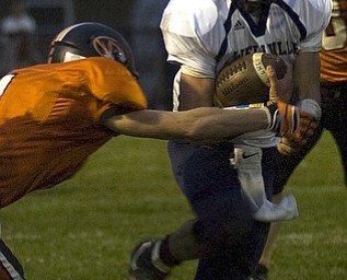 Kelli Cardinal/The Vindicator .Lowellville junior Phil Ginnis avoids the tackle Friday night against Springfield defender Ian Grdina (ok) at Springfield High School.