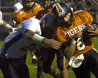 Kelli Cardinal/The Vindicator .Springfield quarterback Hunter Snyder is brought down Friday night by a Lowellville defender in the second quarter at Springfield High School.